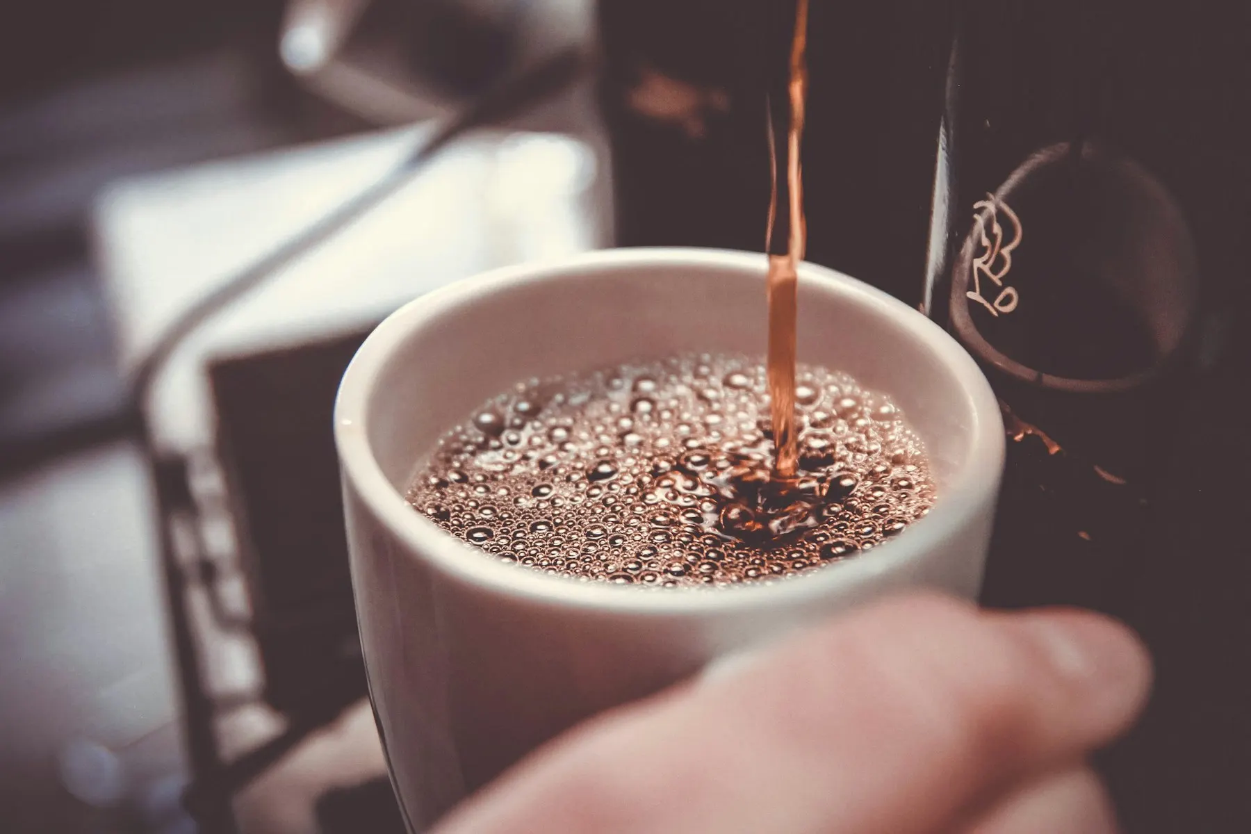 Coffee pouring into a white cup