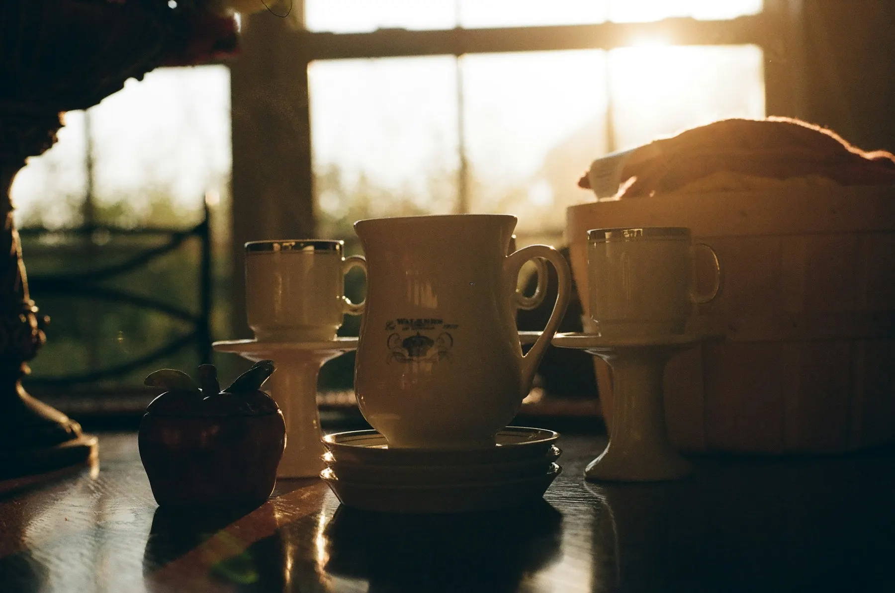 Coffee mugs on a sunlit windowsill